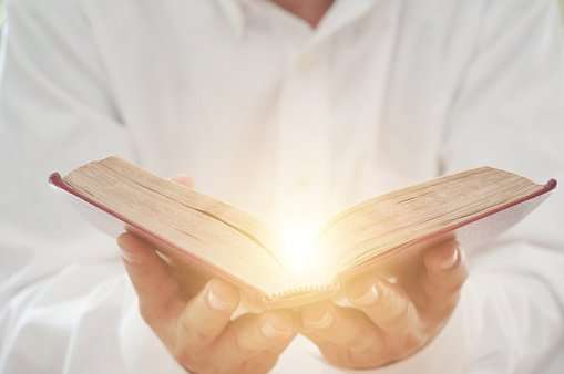 A Man Reading The Holy Bible Stock Photo